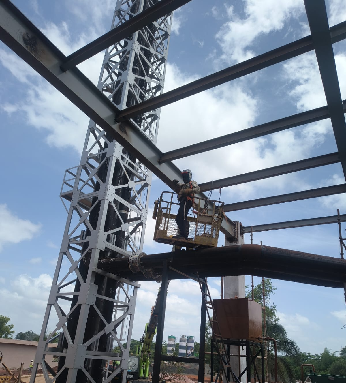 Welder working from a mechanical elevated work platform